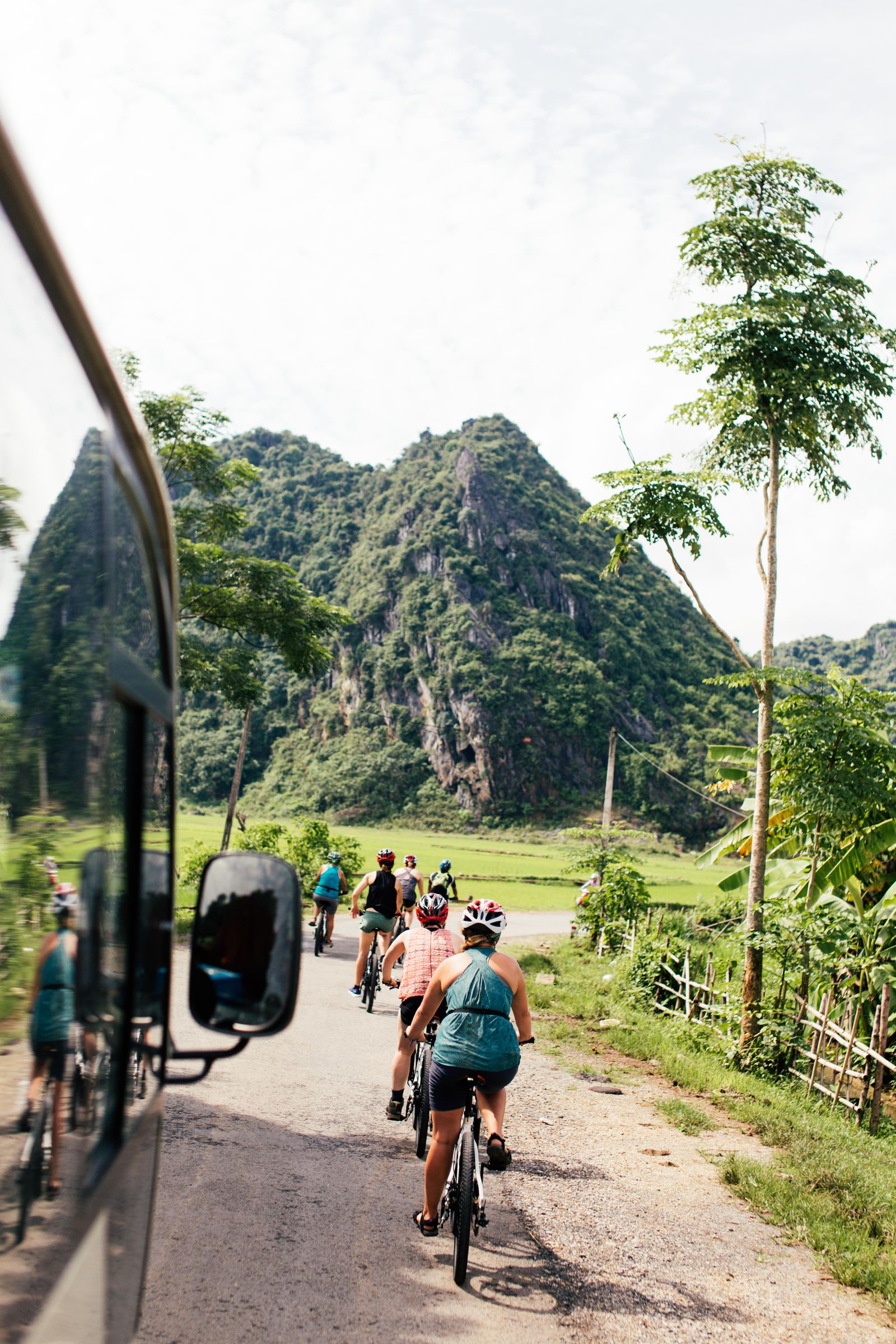 A group cycling through green countryside
